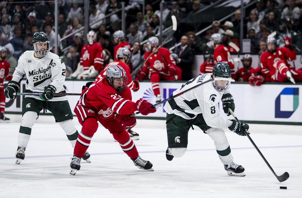 <p>MSU junior defense Maxim Štrbák (8) tries to keep the puck away from OSU senior forward Davis Burnside (23) in the Munn Ice Arena on March 14, 2026. Ohio State defeated Michigan State 3-2 in overtime.</p>
