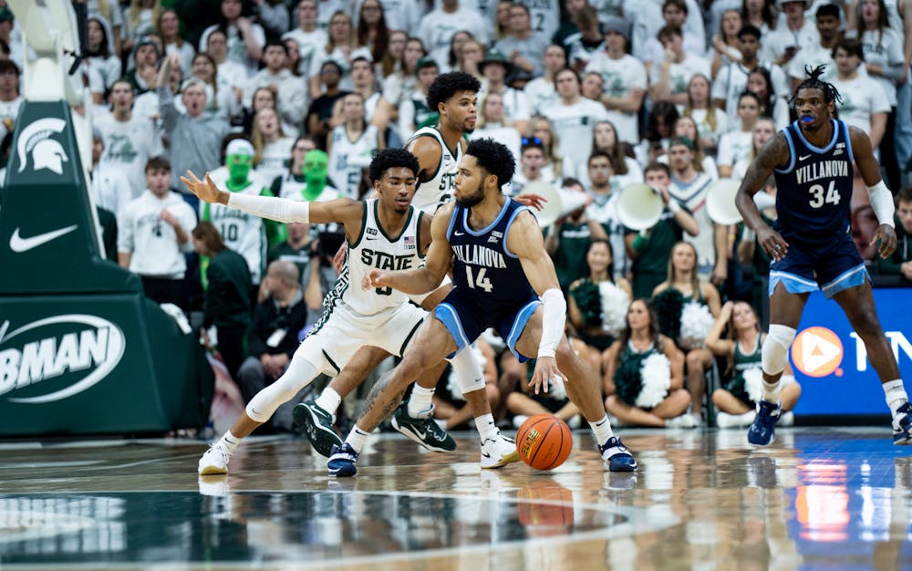 Sophomore guard Jaden Akins (3) guards opponent graduate student guard (14) during a game against Villanova at the Breslin Center on Nov. 18, 2022. The Spartans defeated the Wildcats 73-71. 