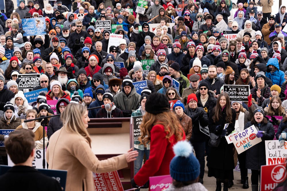 Michigan residents listen to Christen Pollo introduce Emilia Vriesman at the Right to Life March at the Capitol Building on Jan. 28, 2023. 