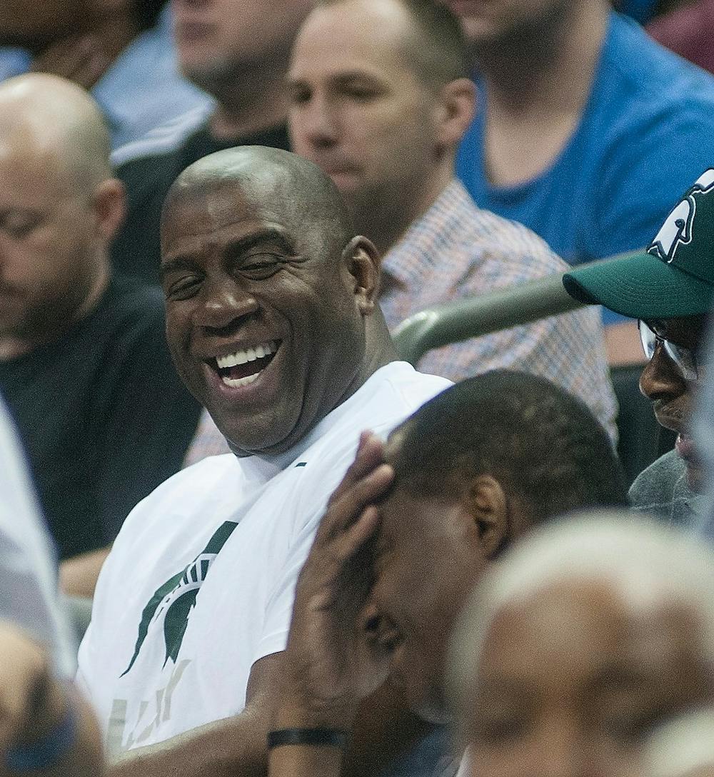<p>Magic Johnson cheers with the crowd Mar. 20, 2015,  during the second round of the NCAA tournament in a game against Georgia at the Time Warner Cable Arena in Charlotte, North Carolina. The Spartans defeated the Bulldogs, 70-63. Alice Kole /The State News</p>
