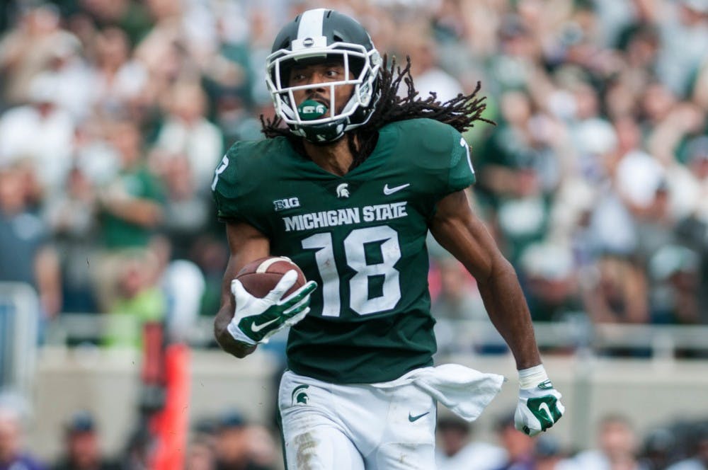 Senior wide receiver Felton Davis III (18) scores a touchdown during the game against Northwestern at Spartan Stadium on Oct. 6, 2018. The Wildcats defeated the Spartans 29-19.