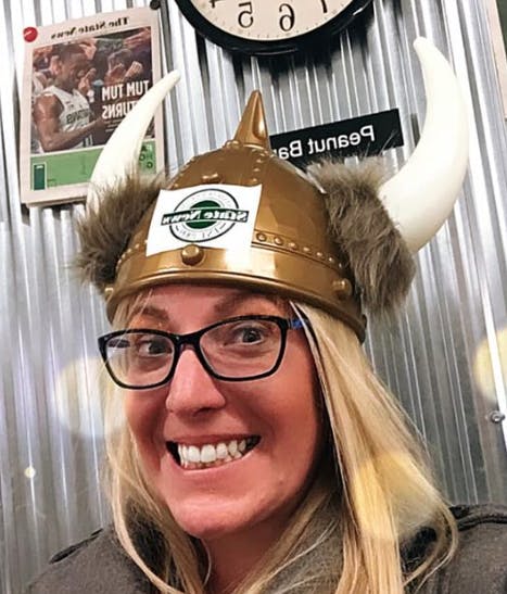 <p>Dawn Klemish (&#x27;05), a writer and producer with MLB.com, gets reacquainted with The State News Viking Helmet (awarded to the newsroom staffer of the week) during her visit to State News offices in January of 2020.</p>