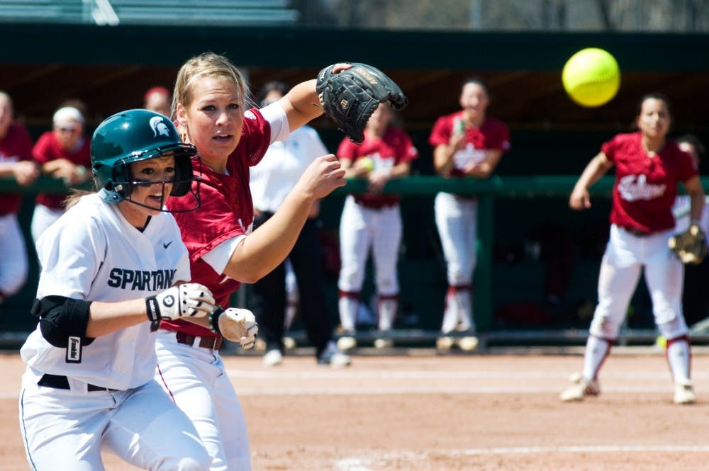 	<p>Sophomore outfielder Kylene Hopkins runs past Indiana pitcher Sara Olson as she attempts to make a catch Saturday afternoon at Secchia Stadium. The Spartans lost Saturday&#8217;s game to Indiana, 7-2. Matt Hallowell/The State News</p>