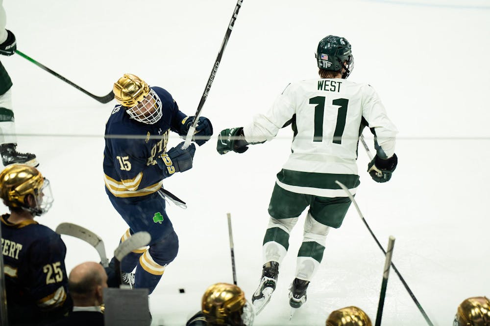 Notre Dame sophomore forward Jayden Davis (15) looks to his teammates on the bench at Munn Ice Arena on March 15, 2025. The Spartans took a 1-0 victory over the Fighting Irish, advancing to the Big Ten Championship.