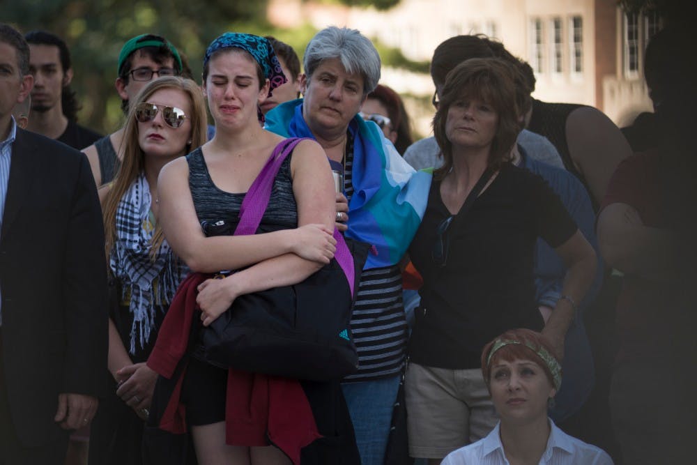 East Lansing resident Aidan Wood, left, weeps during the candlelight vigil for Orlando on June 12, 2016 at the Capitol in Lansing. Lansing Association of Human Rights hosted the vigil for people that wanted to gather and mourn for Orlando's victims of violence.