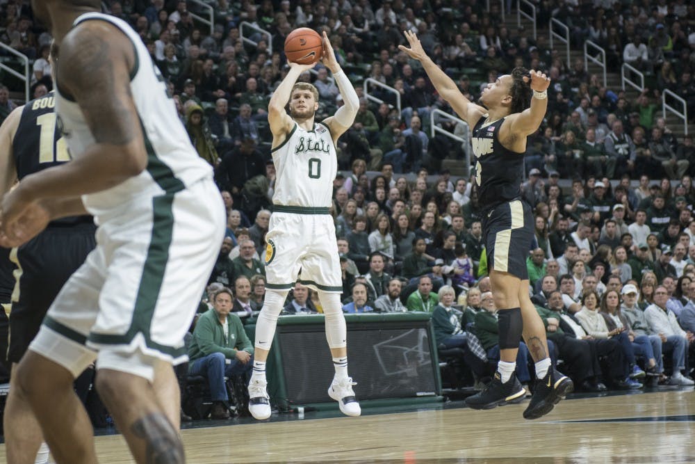 Junior guard Kyle Ahrens (0) shoots the ball during the first half of the men's basketball game against Purdue on Jan. 8, 2018 at Breslin Center. The Spartans led the first half, 39-26.