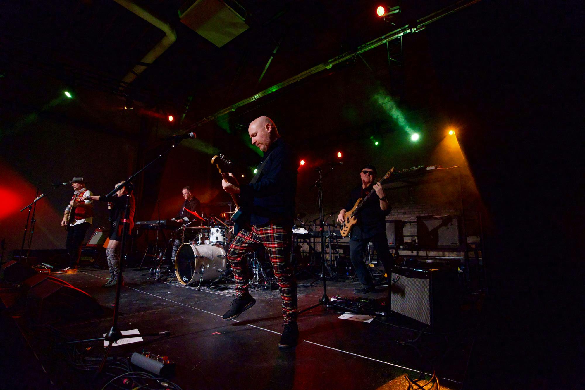 <p>Michigan State University journalism and film professor Troy Hale is onstage with band members while playing the rhythm guitar on Dec. 13, 2024.</p>