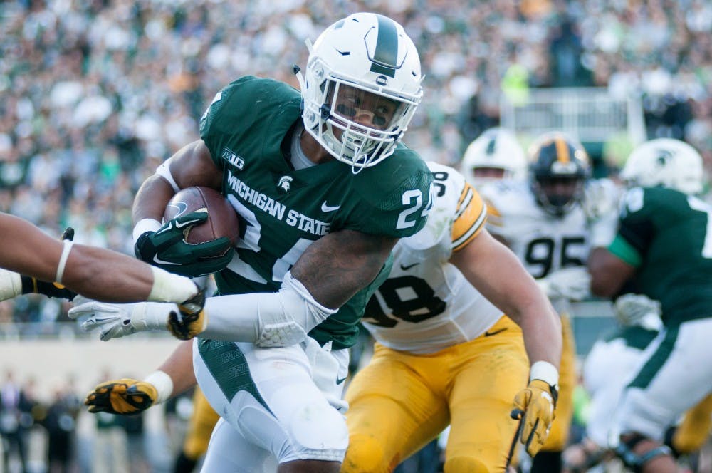 Senior running back Gerald Holmes (24) runs upfield during the game against Iowa on Sept. 30, at Spartan Stadium. The Spartans defeated the Hawkeyes, 17-10.