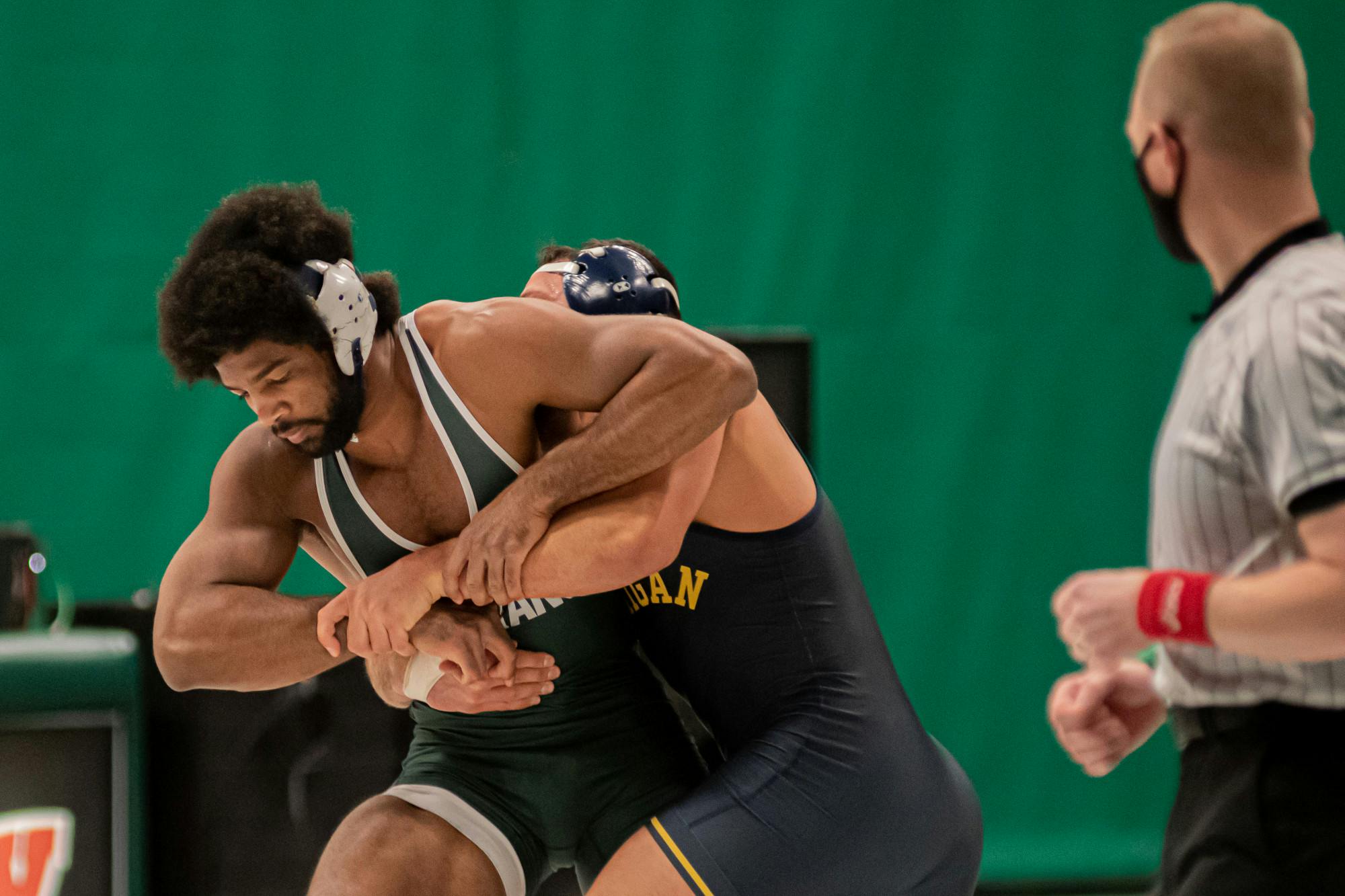 <p>Redshirt junior and No. 10 Cameron Caffey wrestles the No. 1 graduate student Myles Amine on Feb. 19. Caffey lost the match 11-6, dropping his record to 5-2.</p>