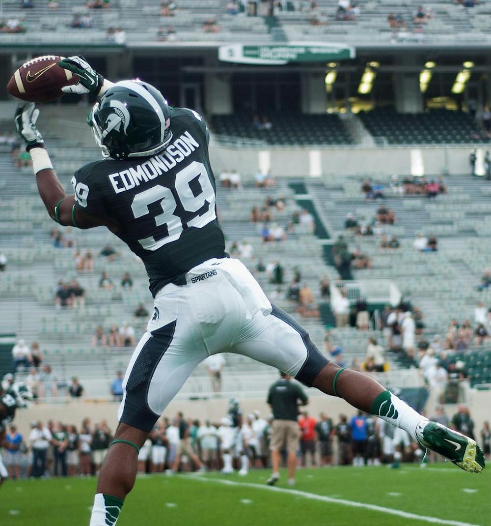 	<p>Freshman cornerback Jermaine Edmondson catches a pass during warm-ups on Aug. 30, 2013, at Spartan Stadium. The Spartans defeated the Broncos, 26-13. Katie Stiefel/The State News</p>