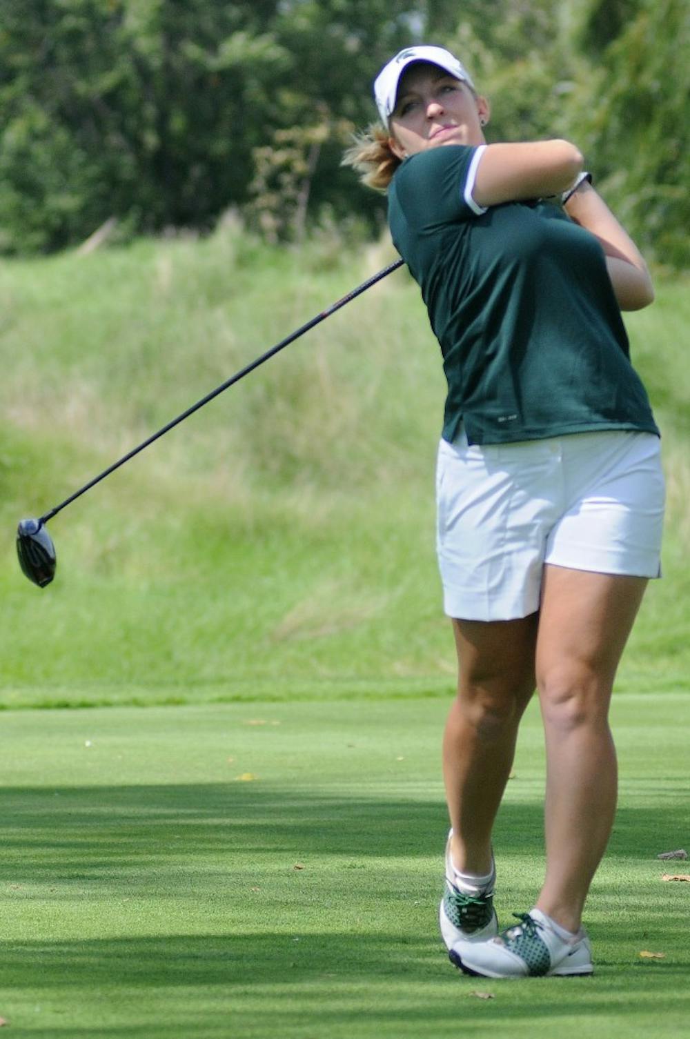 Junior Caroline Powers looks at the direction of the ball after hitting the ball at Forest Akers West Golf Course on Sept. 18 2011. Powers ranked first at the Fossum Invitational among 66 players from 12 colleges. State News File Photo
