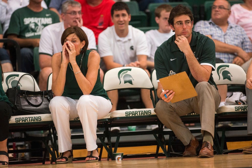 Head coach Cathy George rests her face in her hands during the volleyball game against the University of Florida on Sept. 4, 2016 at Jenison Field House. The Spartans were defeated by the Gators, 3-0.