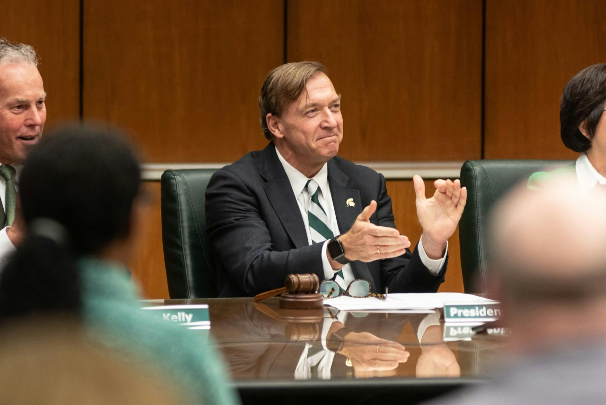 <p>President Samuel L Stanley Jr. (center) applauds new head football coach Mel Tucker (not pictured) after Tucker was approved by the board of trustees at the Hannah Administration Building on Feb. 12, 2020. </p>