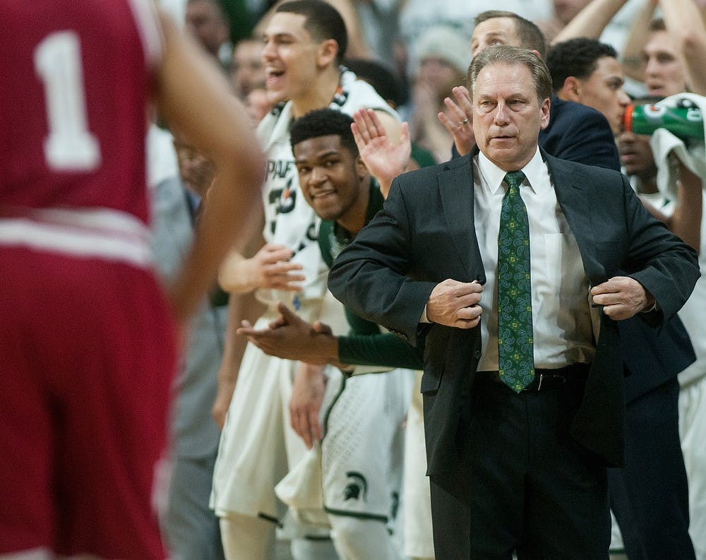 <p>Head coach Tom Izzo adjusts his suit jacket after a Spartan dunk Jan. 5, 2015, during the game against Indiana at Breslin Center. The Spartans defeated the Hoosiers, 70-50. Erin Hampton/The State News</p>