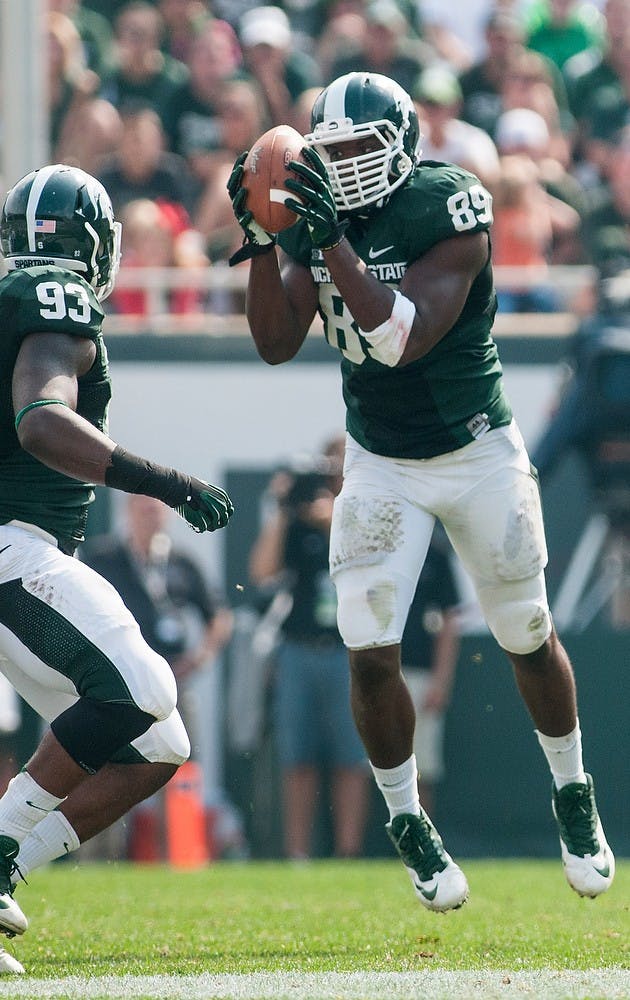 Sophomore defensive end Shilique Calhoun intercepts a pass from South Florida quarterback Bobby Eveld Sept. 7, 2013, at Spartan Stadium. The Spartans topped the Bulls, 21-6. Khoa Nguyen/ The State News