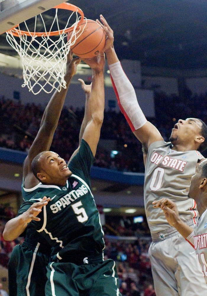 Ohio State forward Jared Sullinger can't quite get the ball to the basket with sophomore center Adreian Payne, and senior forward Draymond who stands behind Payne, stopping his action. The Spartans defeated the Ohio State Buckeyes, 58-48, Saturday night at Schottenstein Center at Columbus, Ohio. /The State News