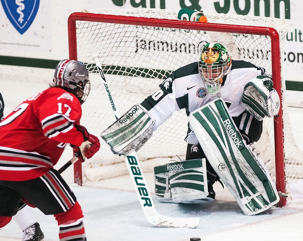 	<p>Freshman goaltender Jake Hildebrand prepares to stop the puck Friday night, Nov. 30, 2012, at Munn Ice Arena. The Ohio State Buckeyes defeated the Spartans, 1-0, with a late goal in the third period. Adam Toolin/The State News</p>