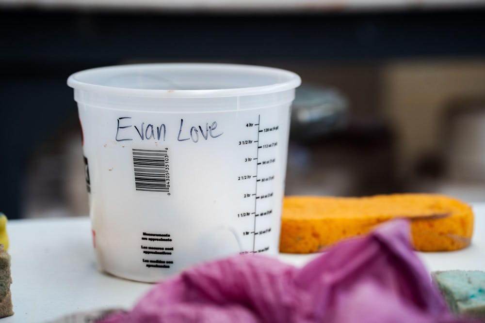 Fourth-year Michigan State studio art student Evan Yalowitz cleans up her workspace in the ceramics studio at Kresge Art Center on April 4, 2025. She had spent the afternoon working on a ceramics project for one of her studio art classes.