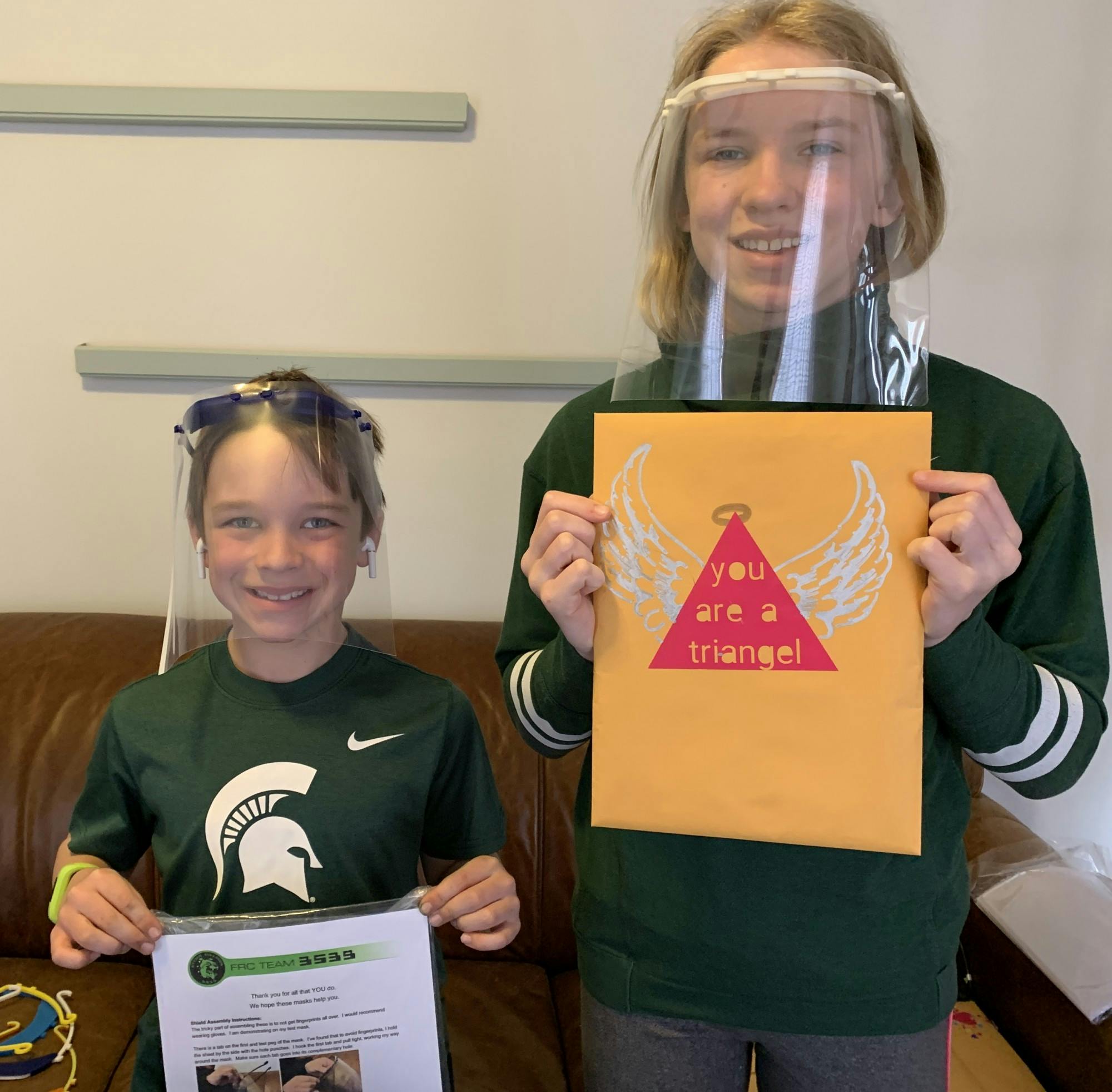 <p>Brayden and Harper Savage wear face shields printed by the FIRST Robotics team from Romeo High School. Photo courtesy Michael Savage.</p>