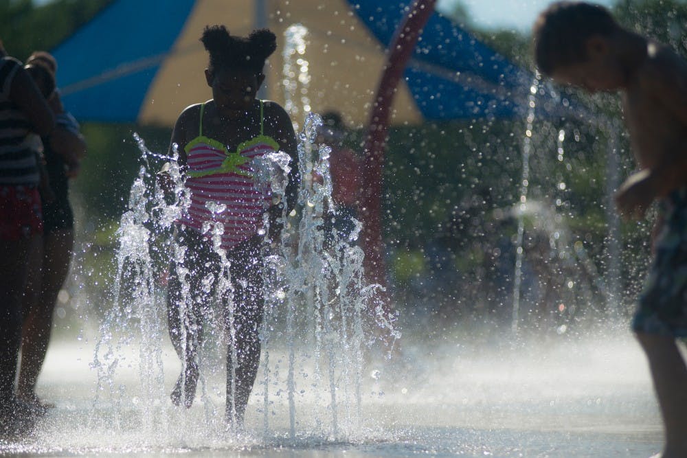 Lansing resident Lauren Hunter, 6,  plays on the splash pad at Hawk Island Park on June 27 at 1601 E Cavanaugh Rd. in Lansing.  In the summer Hawk Island offers swimming features and trails. During the winter the park offers snowboarding. 