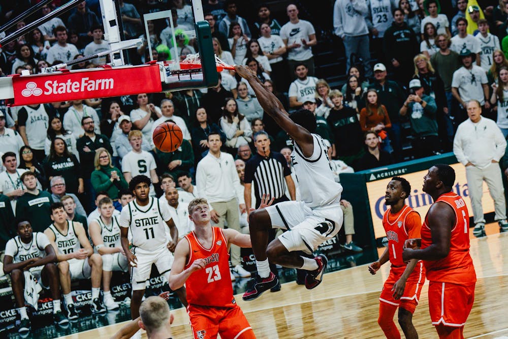 <p>MSU sophomore forward Coen Carr (55) dunks the ball against Bowling Green at the Breslin center on Nov. 16, 2024</p>