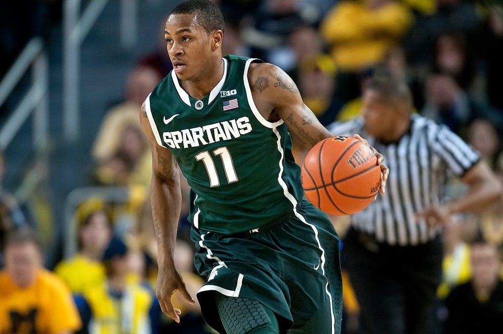 Junior guard Keith Appling dribbles the ball up the court during the game against Michigan on March 3, 2013, at Crisler Center in Ann Arbor. The Spartans lost to the Wolverines, 58-57. Natalie Kolb/The State News
