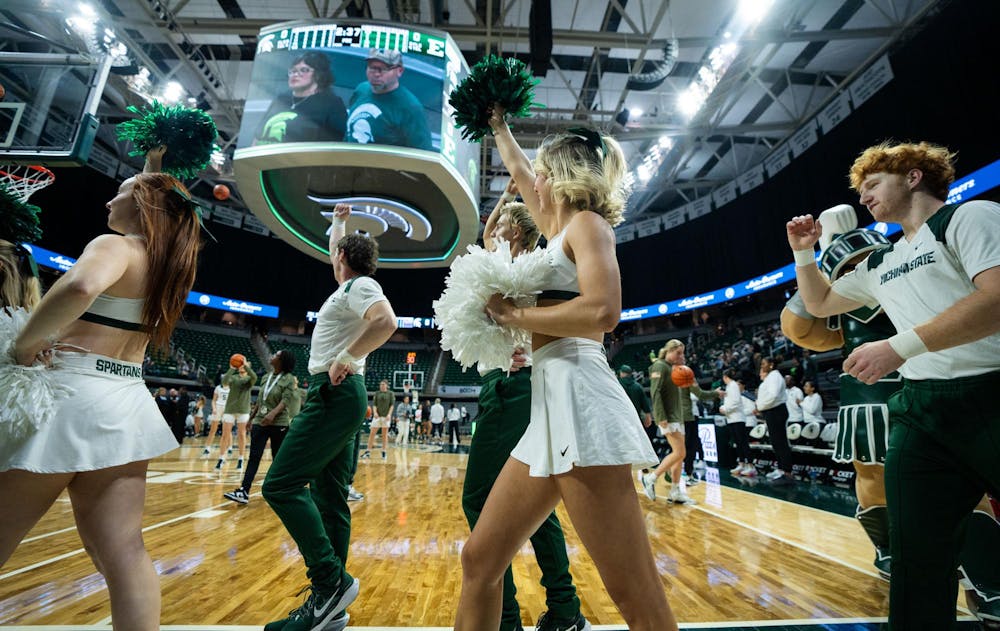 The Michigan State University Cheer Team walks across the court before the game against Eastern Michigan University at the Breslin Center on Nov. 11, 2024. The Spartans secured the win, 95-49, against the Eagles.