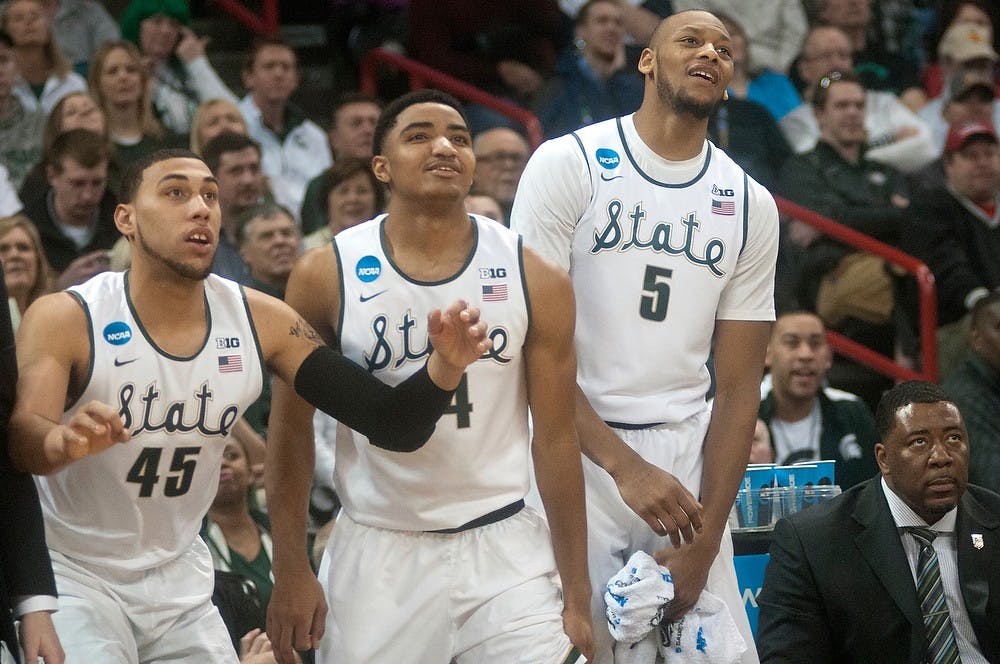 <p>From left to right, sophomore guard Denzel Valentine, sophomore guard Gary Harris and senior center Adreian Payne react to the game against Delaware on March 20, 2014, at Spokane Veterans Memorial Arena during the Spartans' first game in the NCAA Tournament. The Spartans won, 93-78. Betsy Agosta/ The State News</p>