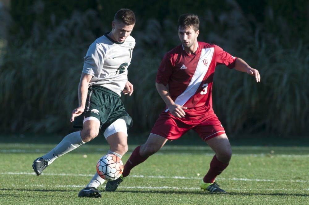 <p>Freshman forward Ryan Sierakowski and Indiana defender Derek Creviston battle for the ball&nbsp;during the men's soccer game against Indiana on Nov. 4, 2015 at the DeMartin Soccer Stadium. The Hoosiers defeated the Spartans, 4-1. </p>