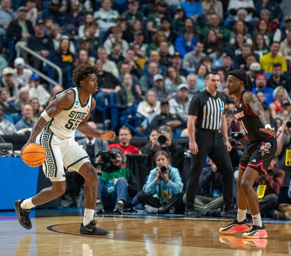 Junior forward Coen Carr (55) dribbles the ball during the March Madness matchup against University of Louisville at the KeyBank Center in Buffalo, New York on March 21, 2026.