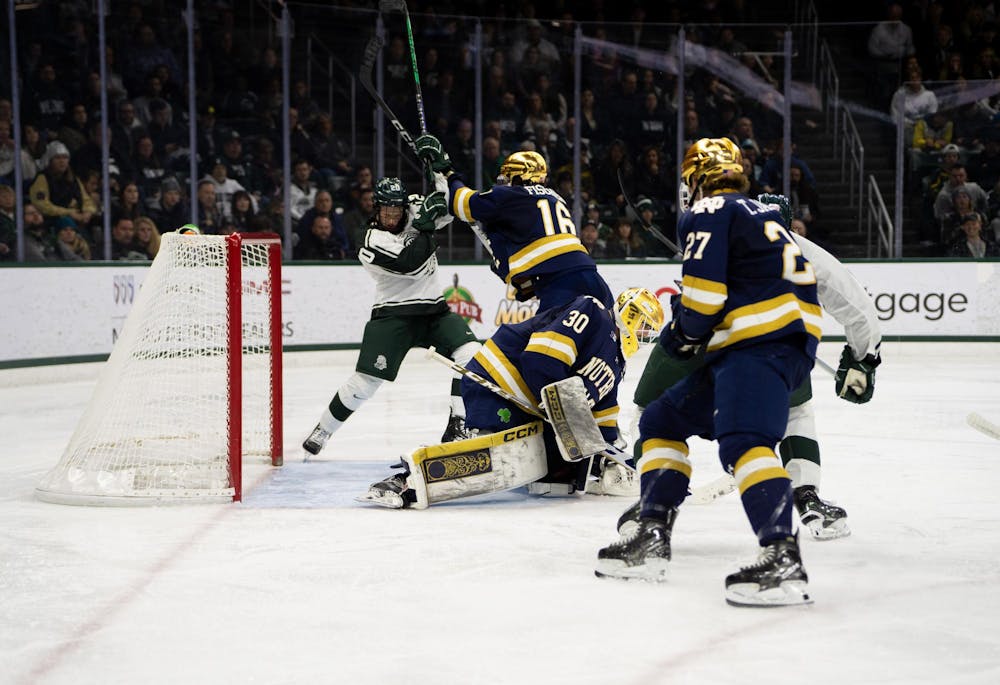 <p>Michigan State Sophomore Forward Daniel Russel (20) gets tangled up with Notre Dame Freshman Defenseman Paul Fischer (16) during their game at Munn Arena on Dec. 8, 2023. Michigan State would go on to win 5-2.</p>