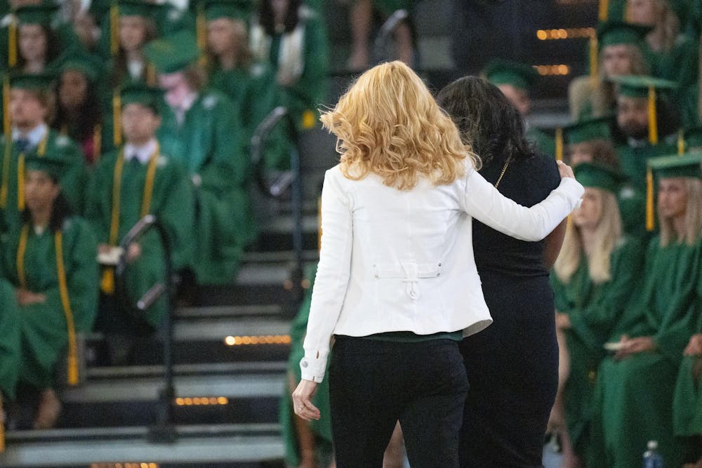 The College of Natural Science honored Alexandria Verner and Arielle Anderson with posthumous degrees accepted by Verner’s god mother and Anderson’s sister on their behalf at the 2023 commencement ceremony on Saturday, May 6, 2023 at the Breslin Center. Verner’s god-mother (left) hugs Anderson’s mother (right) as they approach the stage for the degrees. 