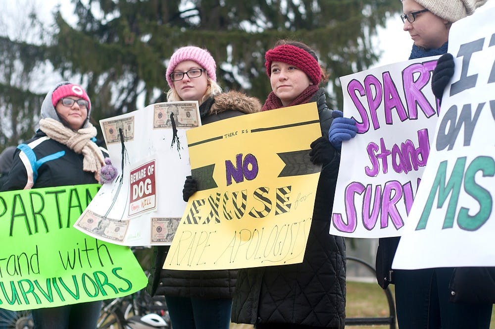 <p>From left, Human biology junior Juliana Peterra, communications junior Anna Skelton, and English junior Lauren Gaynor protest against commencement speaker, George Will Dec. 13, 2014 outside of Breslin Center. This protest was inspired by a column that Will had wrote earlier in the year. Jessalyn Tamez/The State News </p>