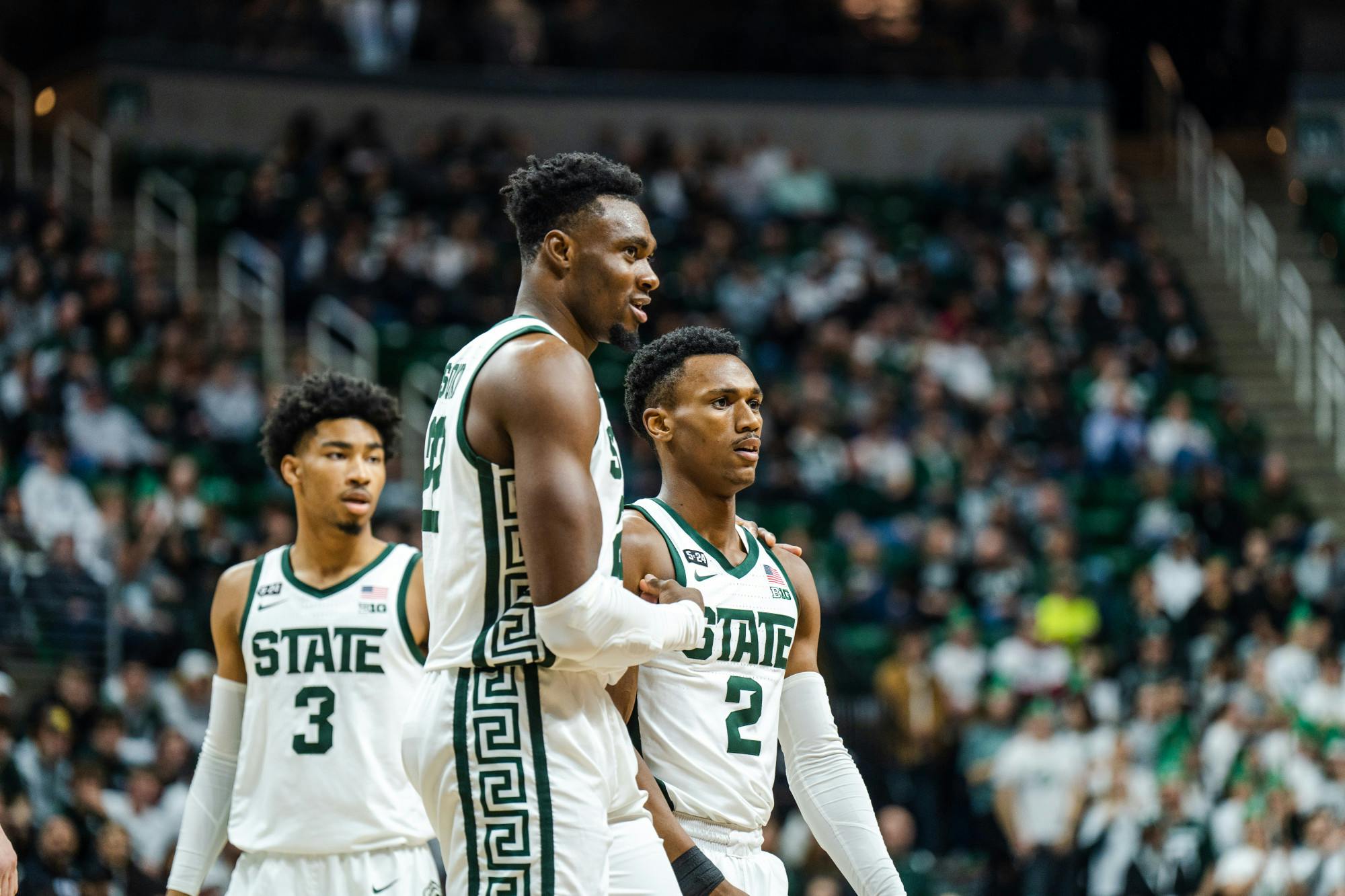 <p>Junior center Mady Sissoko (22) stops to take a breather and speak with his teammates Tyson Walker (2) and Jaden Akins (3) on Feb. 7, 2023. The Spartans defeated the Terps with a score of 63-58.</p>