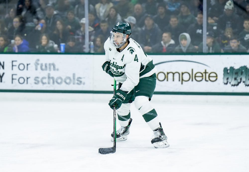 <p>Junior defender Nash Nienhuis (4) is about to pass the puck during a game against Notre Dame at Munn Ice Arena on Feb. 3, 2023. The Spartans defeated the Fighting Irish 3-0.</p>