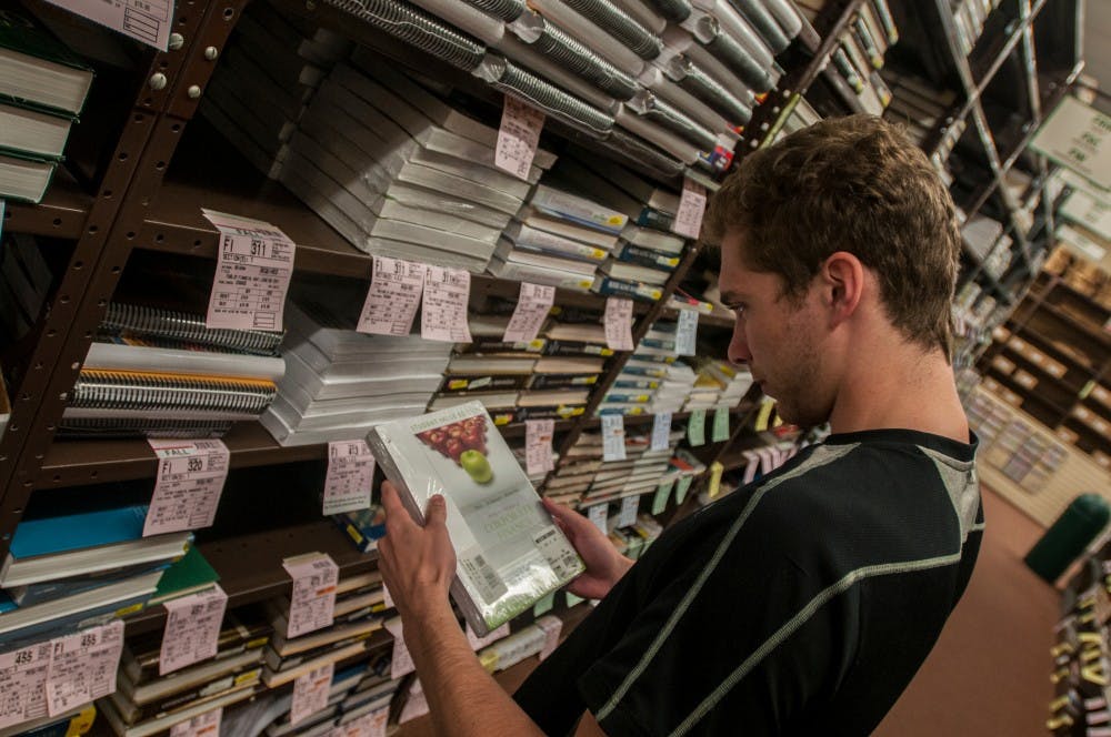 <p>Accounting senior Joe Cox shops for a textbook on Sept. 9, 2016 in the Student Book Store at 421 E. Grand River Ave. Many students struggle with the high and rising prices of college textbooks. </p>