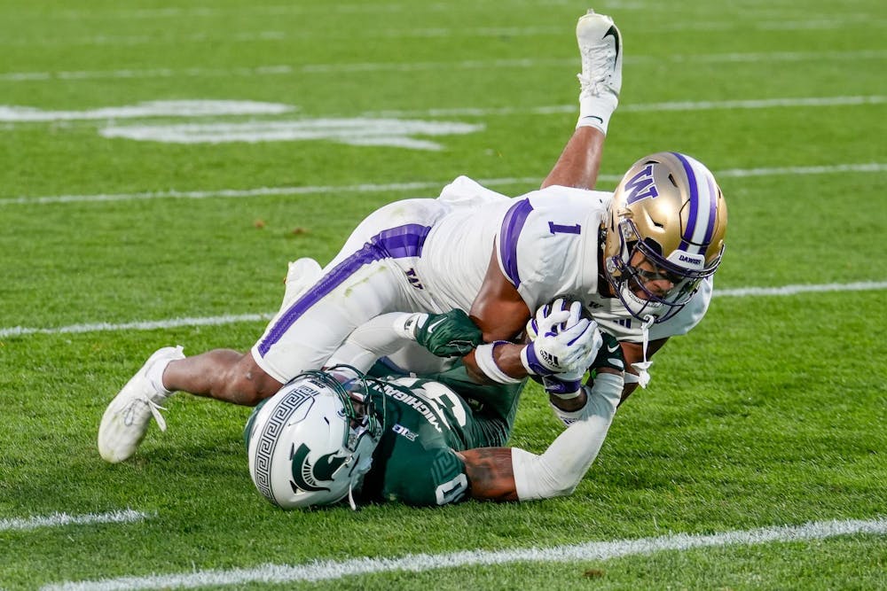 Junior defensive back Charles Brantley (0) attempts to stop a University of Washington player during a game at Spartan Stadium on Sept. 16, 2023.