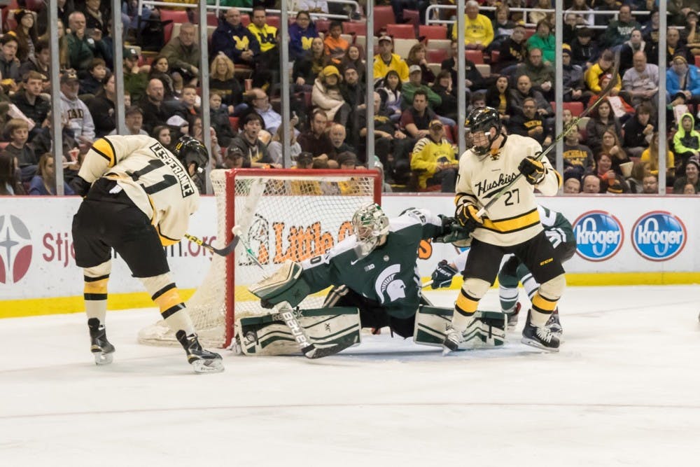 <p>Senior goal tender Jake Hildebrand goes to try to block the puck on Dec. 29, 2015 at the Joe Louis Arena in Detroit.</p>