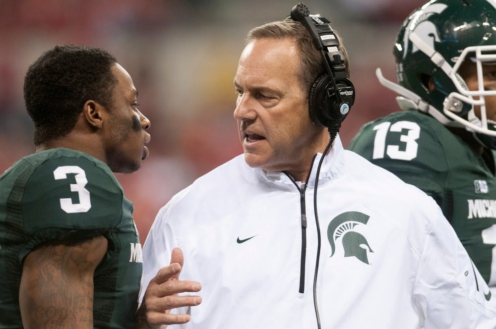 	<p>Head coach Mark Dantonio talks to sophomore wide receiver Macgarrett Kings Jr. at Lucas Oil Stadium in Indianapolis during the Big Ten Championship. Julia Nagy/The State News</p>