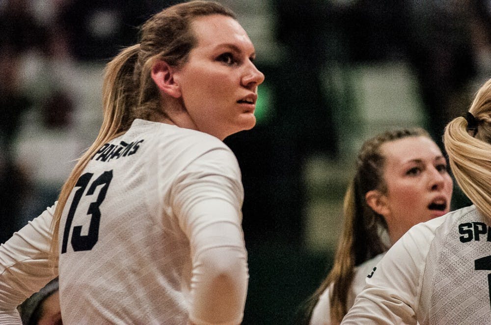 <p>Redshirt senior outside hitter Brooke Kranda (13) and teammates look at the referee after Michigan makes an out-of-bounds call during the game against Michigan on Oct. 18, 2017 at Jenison Fieldhouse. The Spartans secured a 3-1 win against the Wolverines.</p>