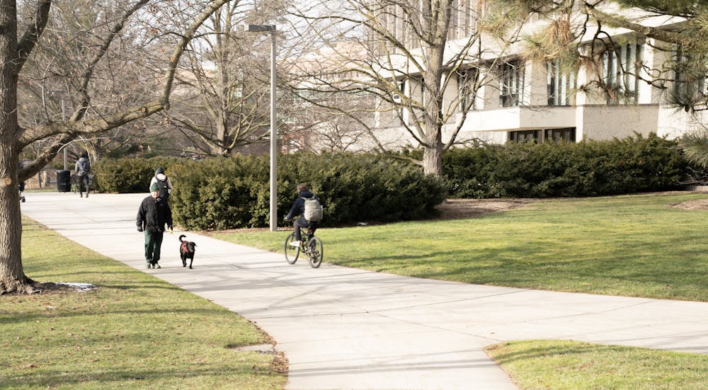 <p>Biker and Dog walker on Campus. Taken on January 24, 2023</p>