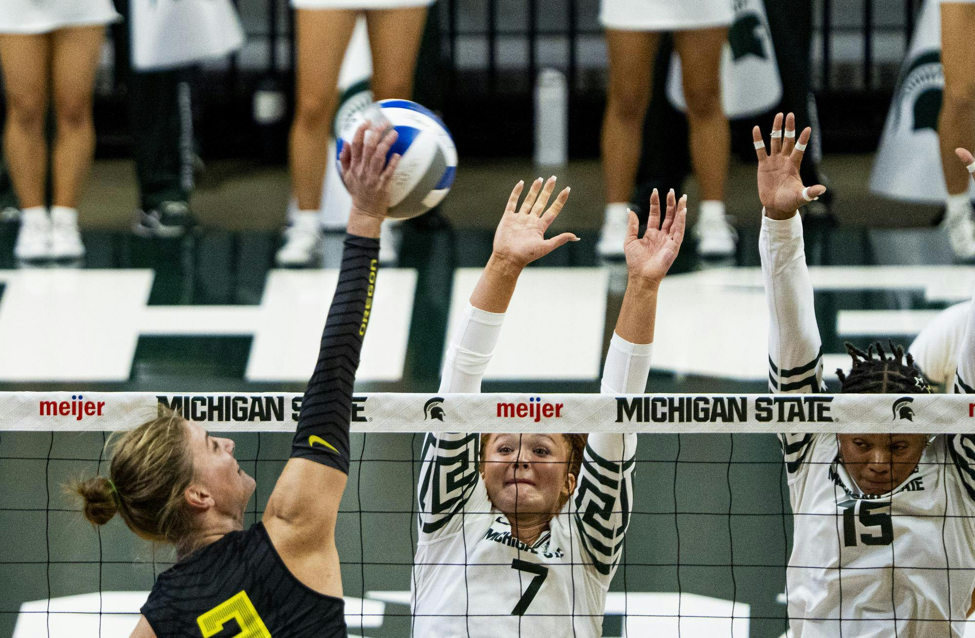 <p>Oregon junior Sjakkie Donkers prepares to spike the ball through MSU senior's Malayah Long and Zora Hardison at the Breslin center in East Lansing, Mich., on Friday, Oct 9, 2026.</p>