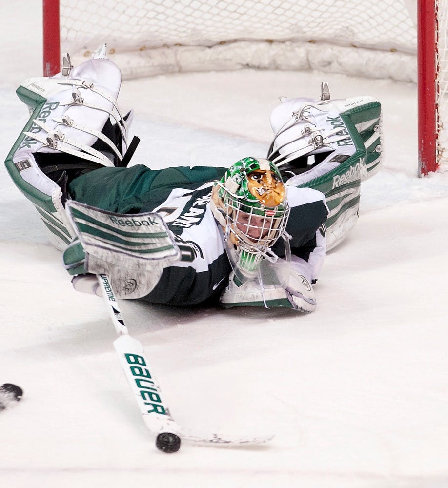 	<p>Freshman goaltender Jake Hildebrand deflects the puck in one of his 33 saves in the game. The Bulldogs defeated the Spartans, 2-1, Friday, Jan. 18, 2013, at Munn Ice Arena. Justin Wan/The State News</p>
