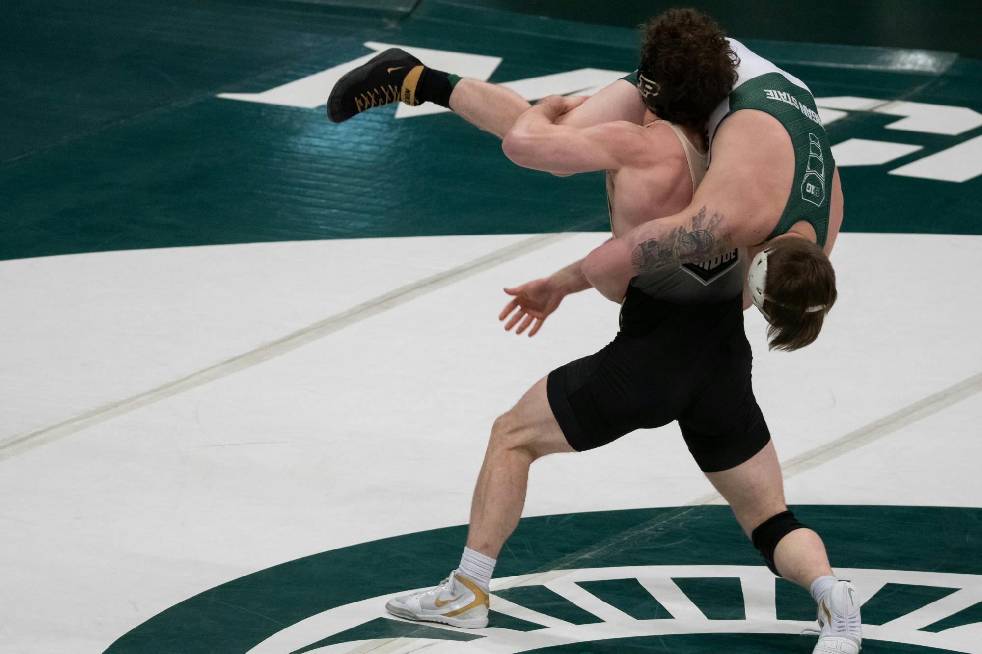 <p>Purdue freshman Emil Soehnlen lifts senior Drew Hughes during the Spartans&#x27; loss to Purdue on Feb. 12, 2021.</p>