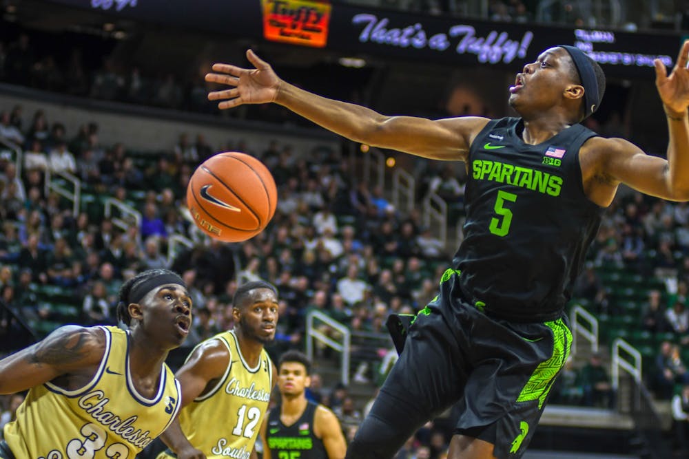 <p>Senior guard Cassius Winston (5) takes the ball during the game against the Charleston Southern Buccaneers on Nov. 18, 2019 at Breslin Center. The Spartans lead the Buccaneers at the half, 40-18.</p>