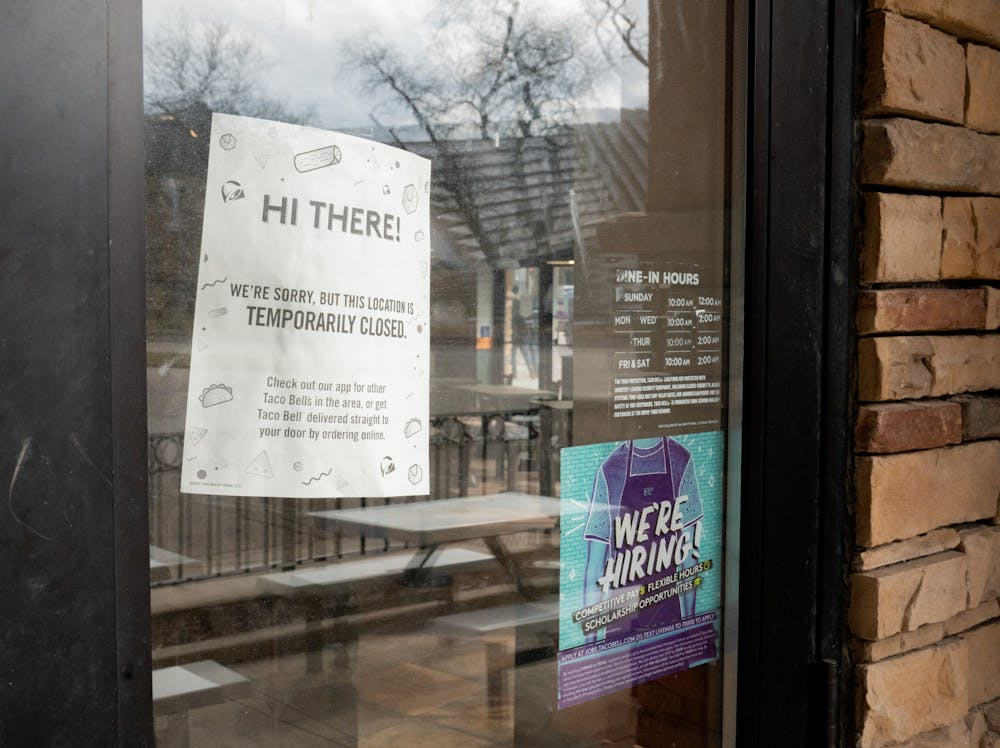 A "temporarily closed" sign hangs in the window of the Taco Bell on Grand River Ave. in East Lansing, Michigan on Feb. 24, 2022.