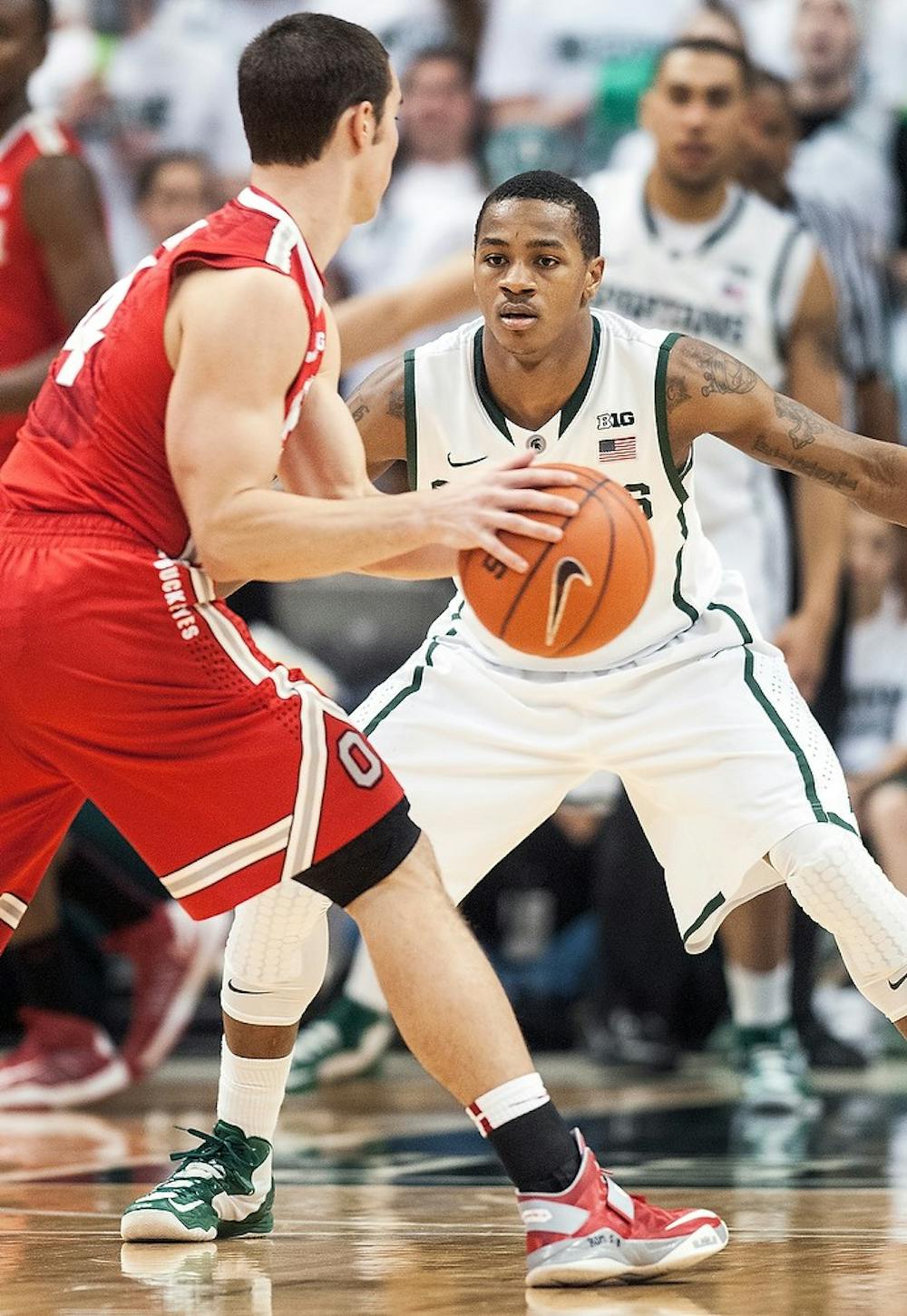 	<p>Junior guard Keith Appling plays defense against Ohio State guard Aaron Craft on Jan. 19, 2013, at Breslin Center.  Adam Toolin/The State News</p>