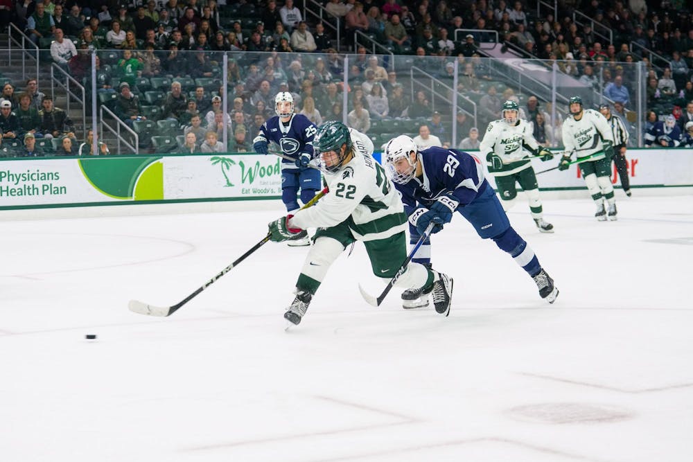 <p>Sophomore forward Isaac Howard (22) taking a shot on goal during a game against Penn State at the Munn Ice Arena on Nov. 10, 2023. Howard would score the goal and add one assist to his stat line before the end of the game.</p>