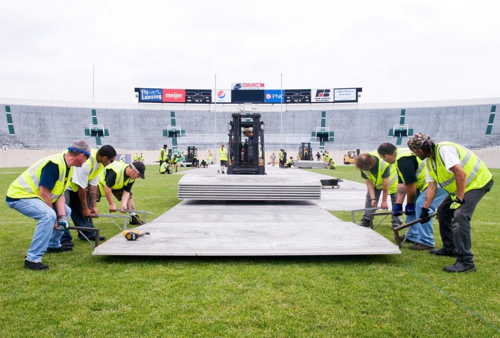 	<p>Workers move metal panels onto the field Monday at Spartan Stadium. Work began today to prepare the Stadium for U2&#8217;s 360 tour, which comes to East Lansing on Sunday.</p>