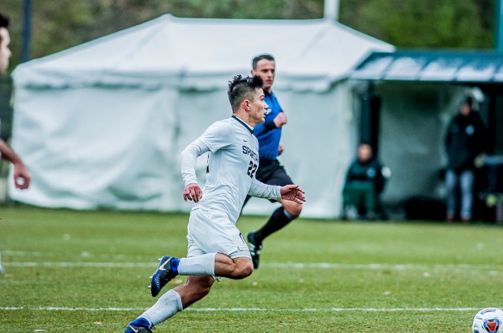 Senior midfielder Ken Krolicki (22) dribbles the ball upfield during the game on Nov. 19, 2017 at DeMartin Stadium. The Spartans defeated the Hokies, 3-0, advancing them to the third round of the NCAA Soccer Tournament. 